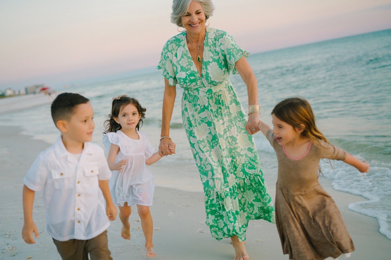 Grandma and kids playing on the beach photograph
